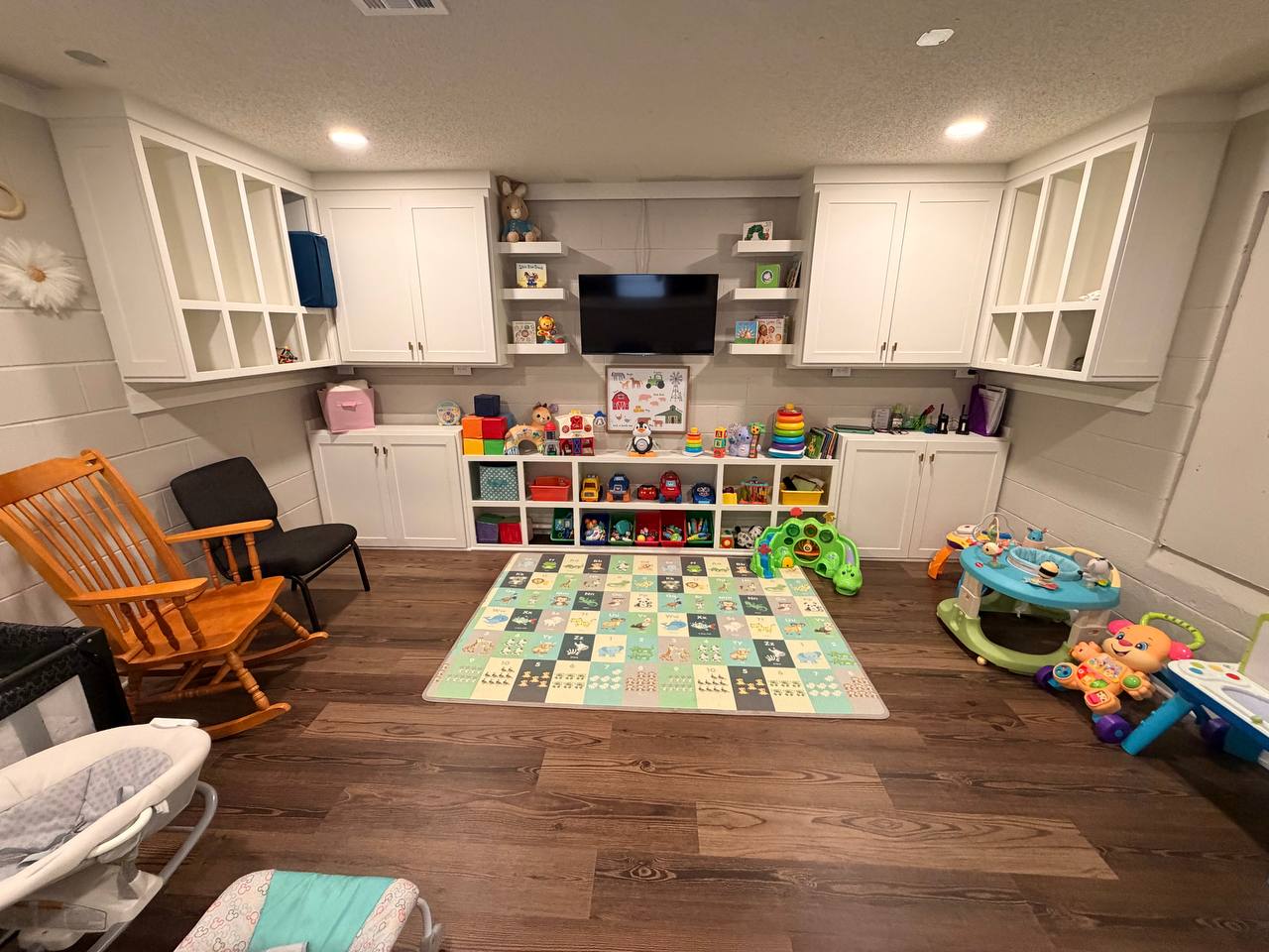 Infant room — full wall of custom white cabinetry