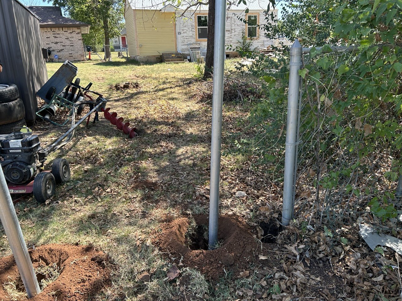 Augering post holes along the property line