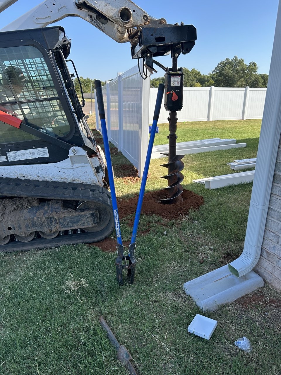 Augering post holes through Oklahoma red clay