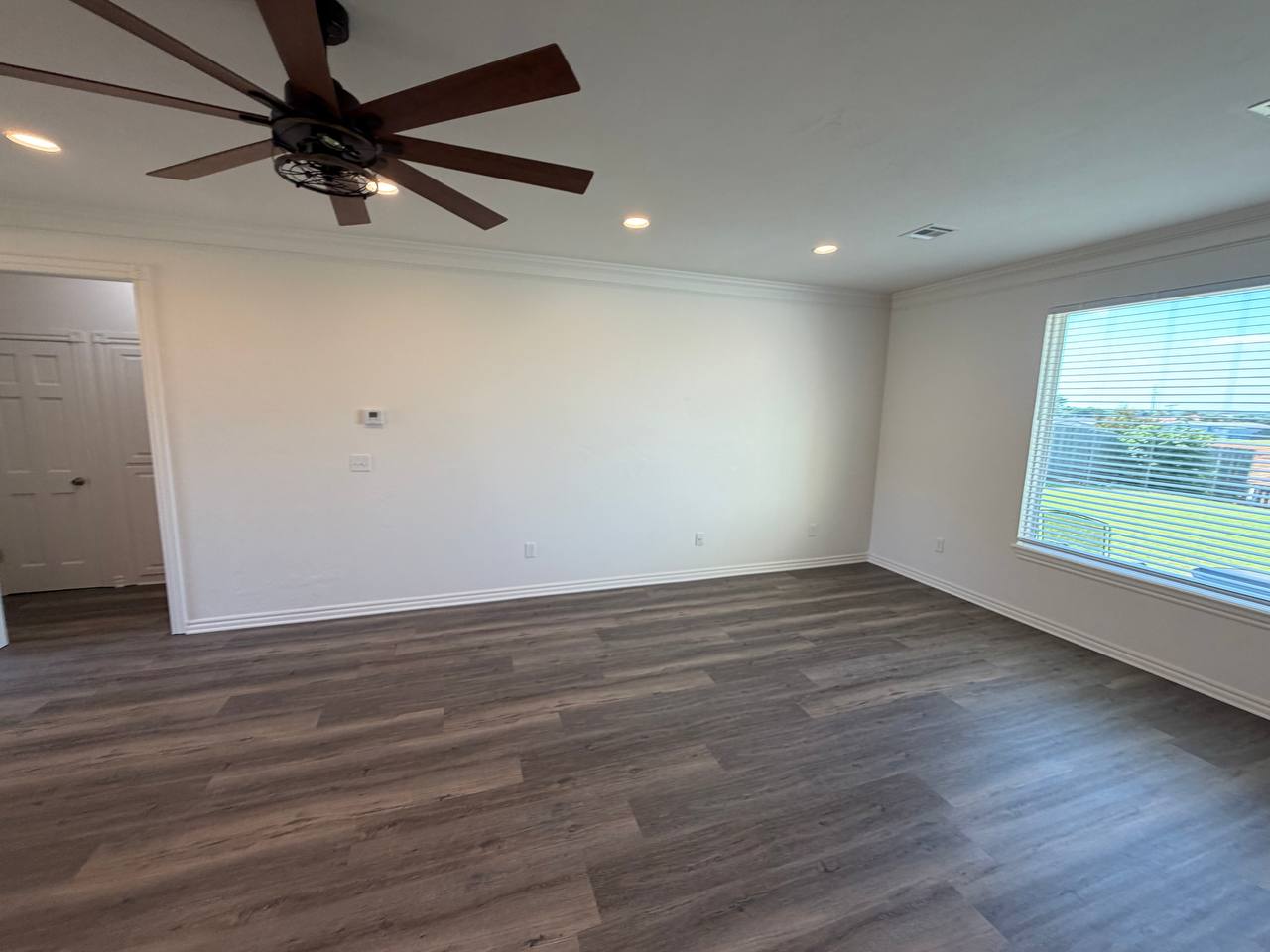 After — open living room with wide-plank flooring