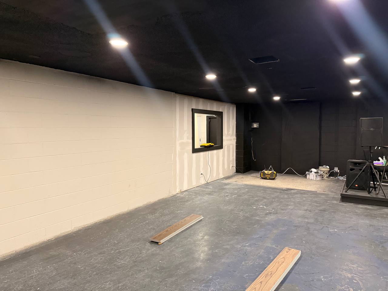 In progress — new wall framing, paint, and flooring staged