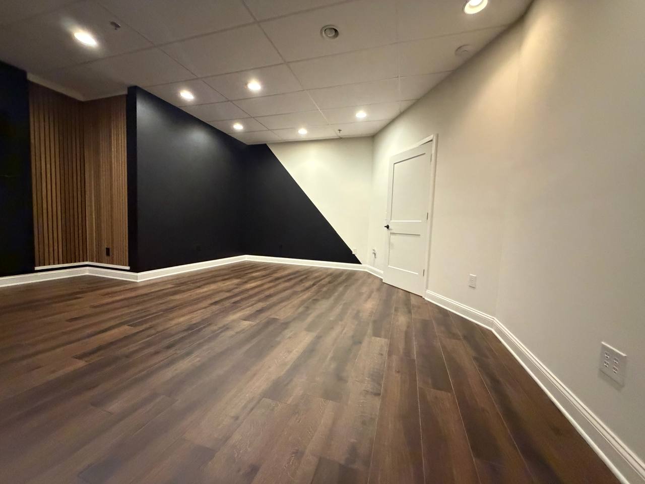 After — two-tone wall, new flooring, and trim complete