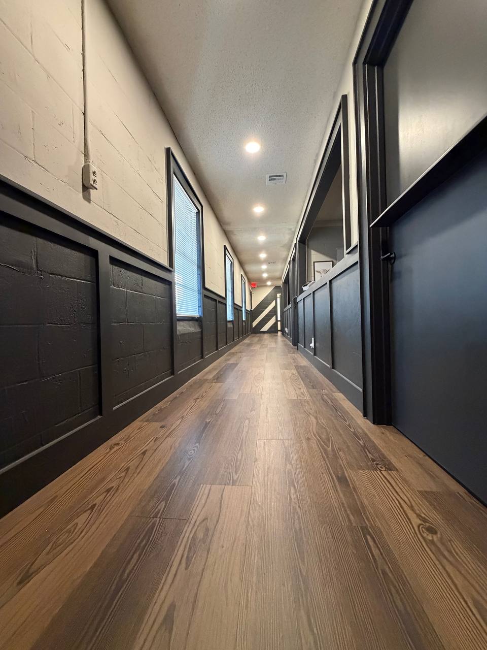 Connecting hallway — new wainscot trim and wood-look flooring