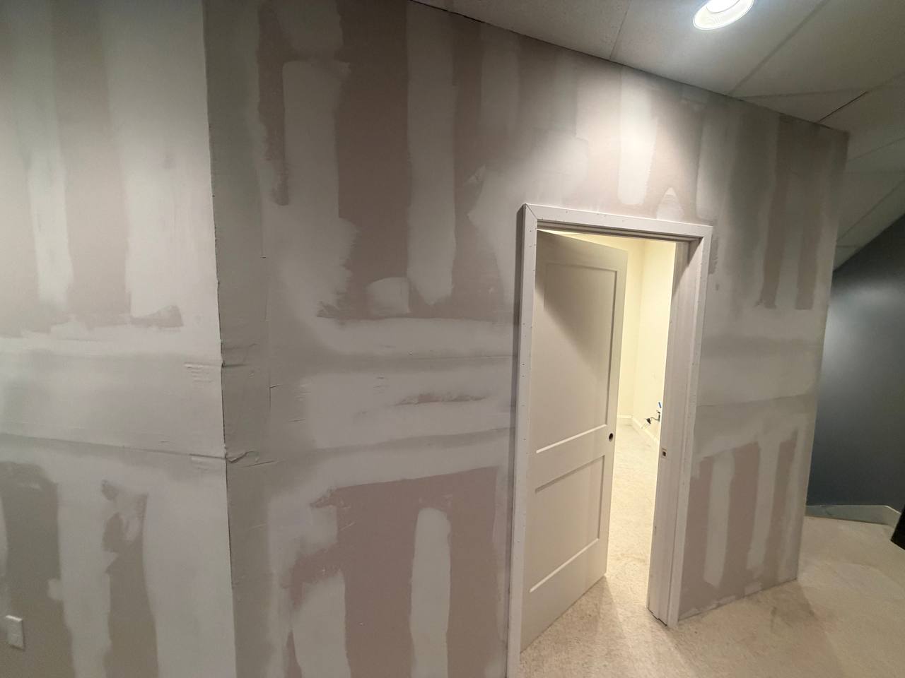 Drywall taped and mudded, new door hung