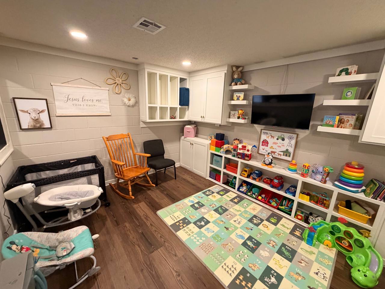 Infant room — built-in cubbies and floating shelves