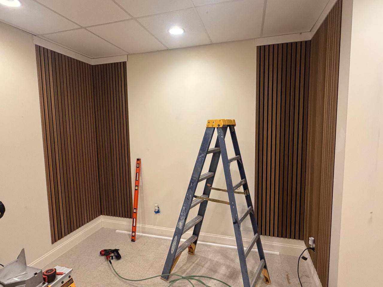 Wood slat accent paneling installed on the set walls