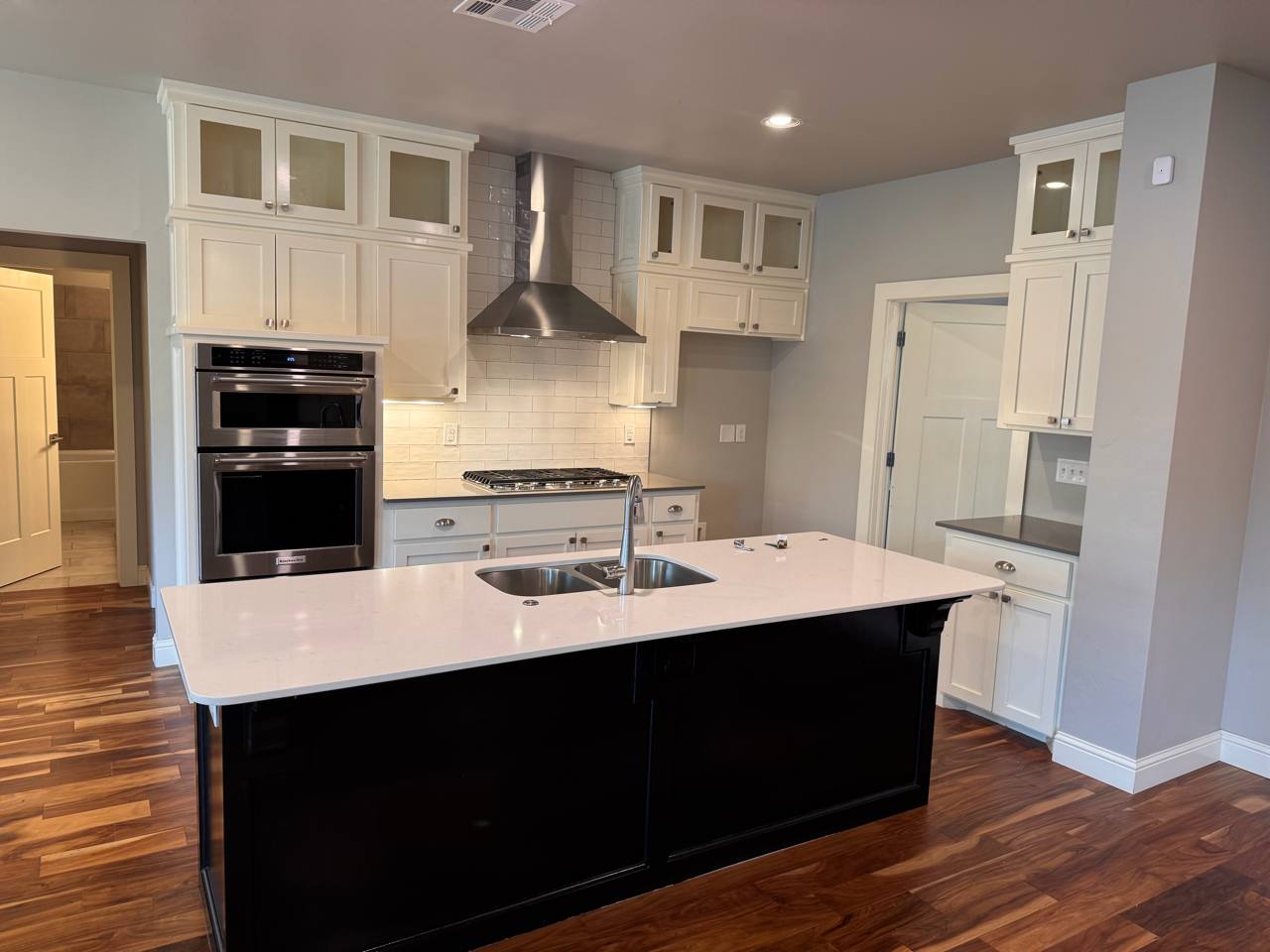 Before — original white cabinets & black island