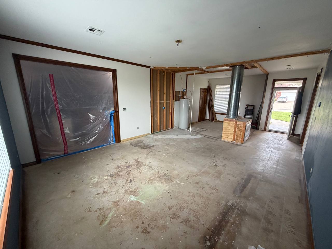Before — demo, exposed framing & bare concrete
