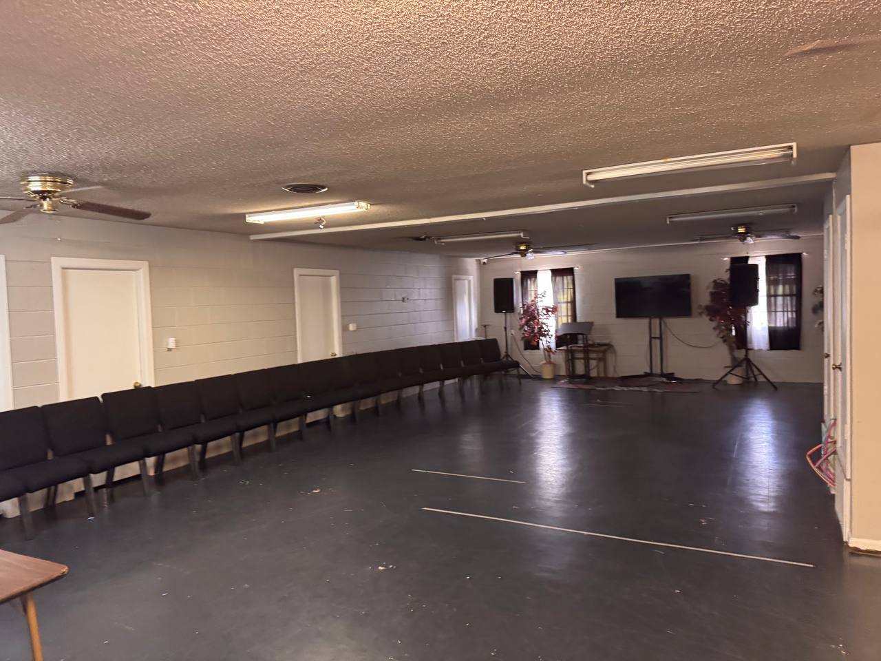 Before — original auditorium with drop lighting and bare block walls