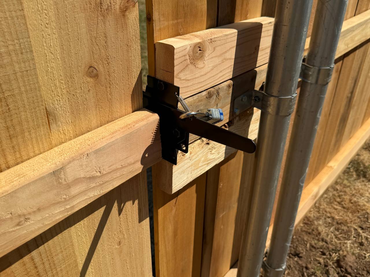 Heavy-duty black gravity latch installed